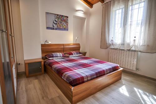 a bedroom with a bed with a plaid blanket at Ca' de Paggia in Savona
