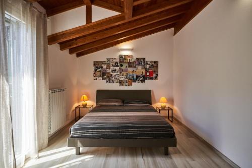 a bedroom with a bed in a room with wooden ceilings at Ca' de Paggia in Savona