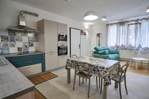 a kitchen and living room with a table and chairs at Ca' de Paggia in Savona