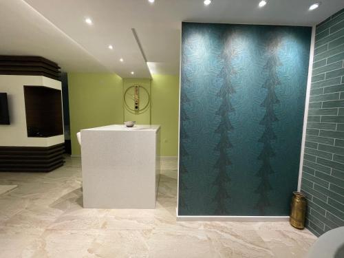 a room with a wall with christmas trees on it at Spa apartman Sobhe in Vrnjačka Banja