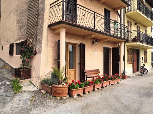 a row of flower pots on the side of a building at Casa Giorgio Mille Papaveri Rossi in Cesi