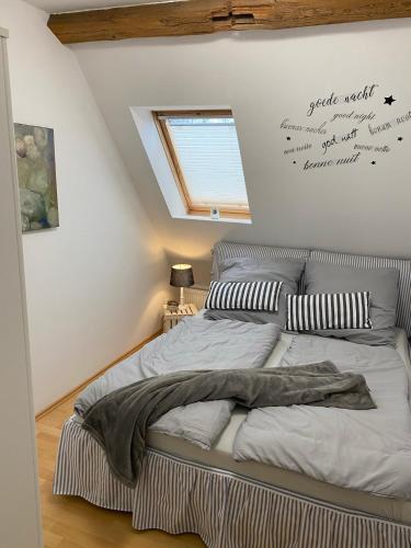 a bed in a room with aigraphy on the wall at FeWo Casa in Boizenburg