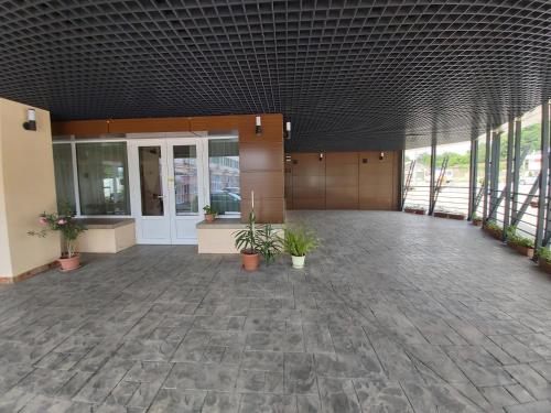 an empty lobby with plants in a building at Hotel Amadeo in Iaşi