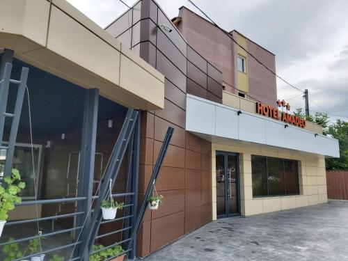 a building with a have hugs sign on it at Hotel Amadeo in Iaşi