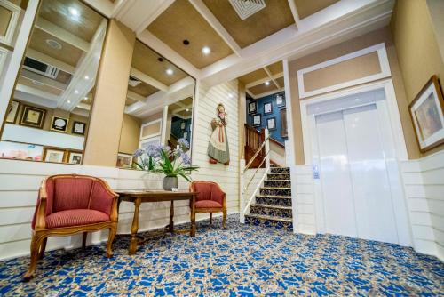 a hallway with a table and two chairs at European Hotel in Perth