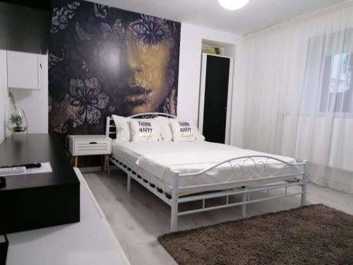 a bedroom with a bed and a black and white wall at Alexandra House in Costinesti