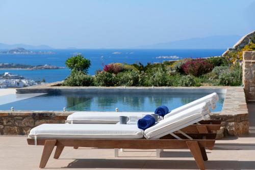 a bed on a table next to a pool at Naxos Rock Villas in Stelida