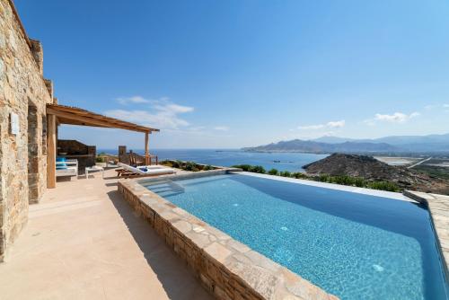 a swimming pool in a villa with a view at Naxos Rock Villas in Stelida