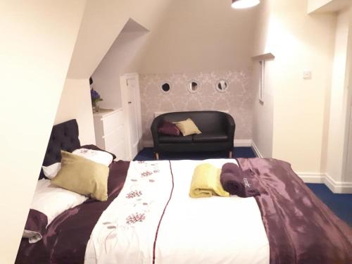 a bedroom with a bed and a chair at PEACEFUL RETREAT HIDEAWAY SURREY in Esher