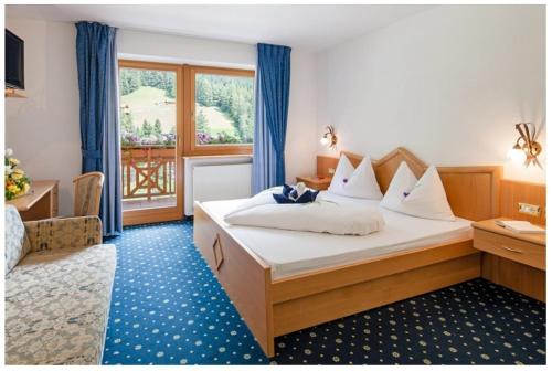 una camera d'albergo con letto e finestra di Hotel Bergkristall a Brennero
