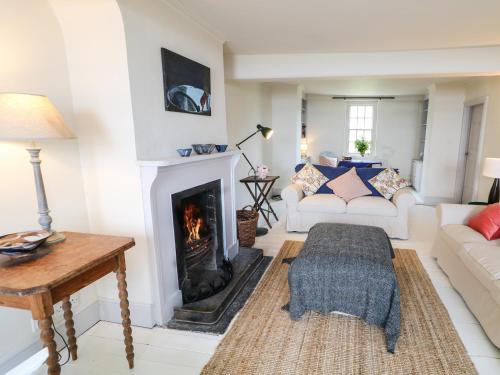 a living room with a fireplace and a couch at The Ferry House in Ramelton