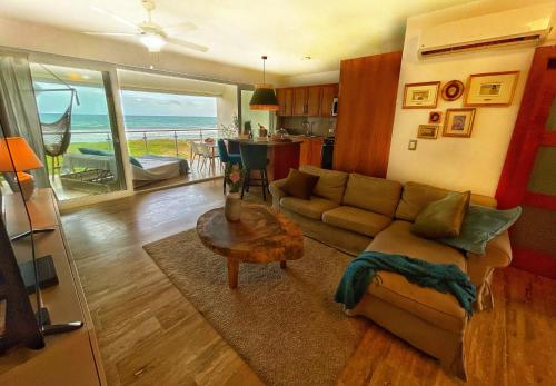 a living room with a couch and a table at Residencial Mañanero in Cabarete