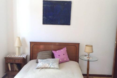 a bedroom with a bed with two pillows on it at Casa Isabel 2 bedroom apartment near Porto in Fânzeres
