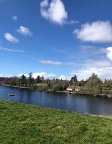 a lake with a boat in the water at Keenaghan Cottage Belleek Fermanagh Northern Ireland in Belleek
