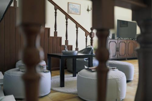 a living room with a table and a staircase at Sea Breeze - BeachHouse in Mindelo