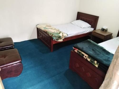 a room with two beds and a couch in it at High Cliff Guest House in Khaplu