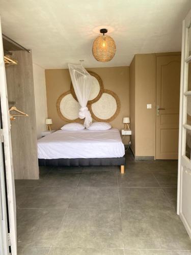 a bedroom with a white bed with areath on it at Anoli Lodge in Petit-Bourg