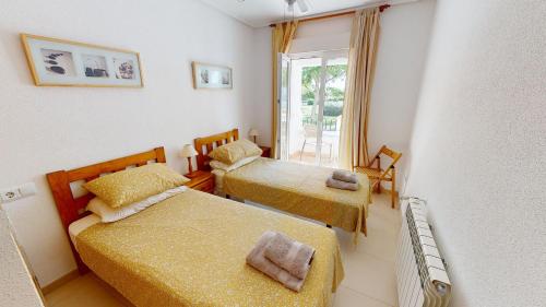 a small bedroom with two beds and a window at Casa Indico RP-Murcia Holiday Rentals Property in Sucina