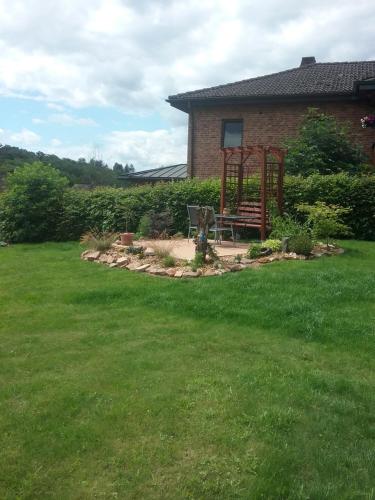 a garden with a bench in the middle of a yard at Schöne Aussicht in Vöhl
