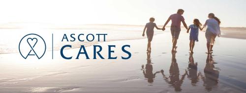 a family walking on the beach with a sign that says acct cares at Ascott Raffles Place Singapore in Singapore
