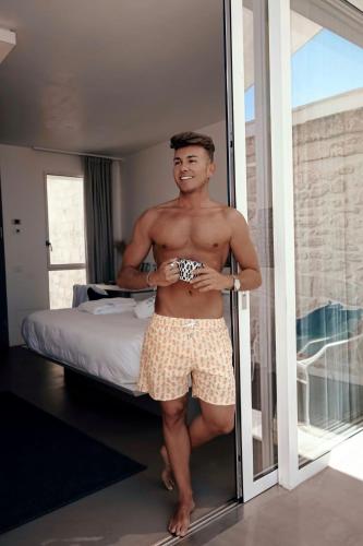 a man is standing in front of a mirror at Antico Mondo Rooms & Suites in Polignano a Mare