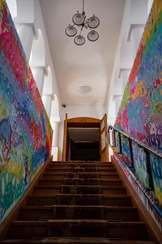 a staircase in a building with colorful walls at Grandhotel Sluchátko - EX Zámecký hotel in Vranov nad Dyjí