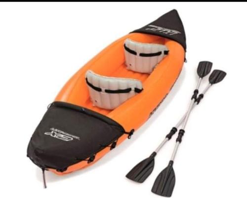 an orange kayak with two paddles and two oars at Discoverequador in Tonsupa