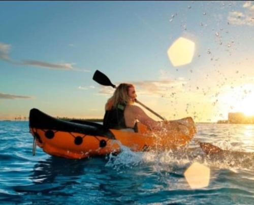 a woman is sitting in a boat in the water at Discoverequador in Tonsupa