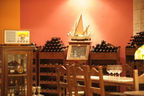 a dining room with a table with a boat on the wall at Roxani Country House Resort in Maronia