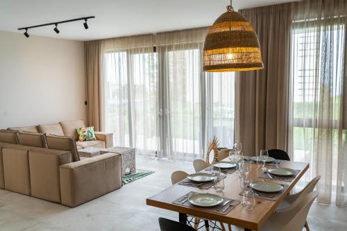 a dining room with a table and a couch at Buena Vista Villas in Varna City