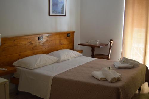 a bedroom with a bed with two towels on it at B&B Casa di Mamma in Corato