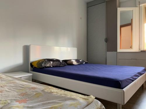 a bedroom with two beds with blue sheets at Florindas Apartment Qerret in Golem