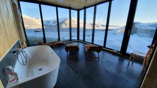 a bath tub in a room with a view of mountains at Jugendgästehaus Gerlosplatte in Krimml