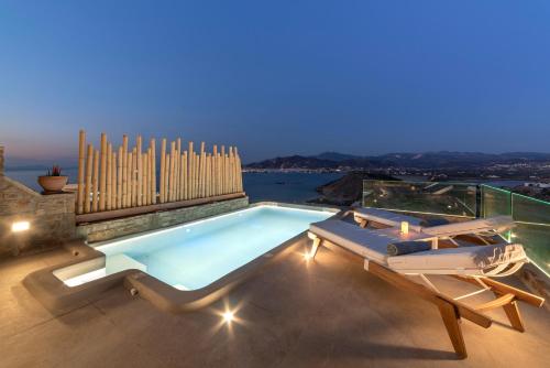 a swimming pool on the roof of a house at Naxos Rock Villas in Stelida