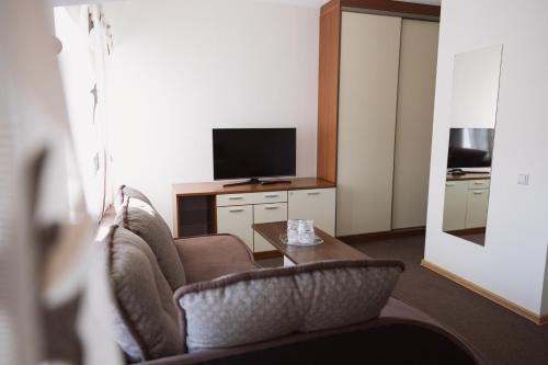 a hotel room with two chairs and a television at Motelis Gariūnai in Vilnius