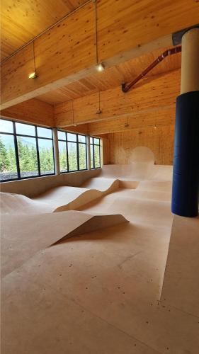 a large room with a skateboard ramp in it at Jugendgästehaus Gerlosplatte in Krimml
