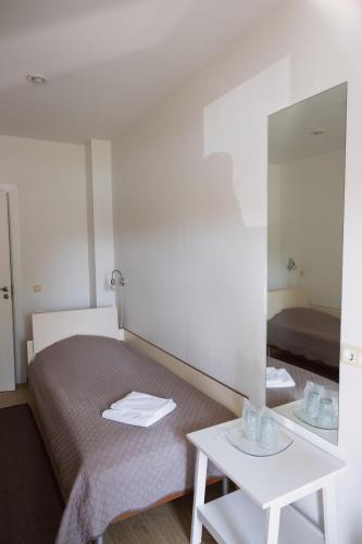a hotel room with a bed and a mirror at Motelis Gariūnai in Vilnius