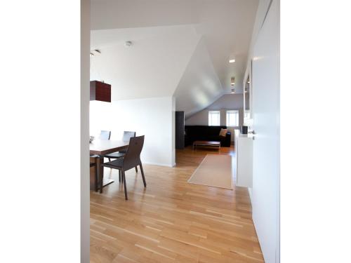 a dining room and living room with a table at Torg Guest House in Akureyri