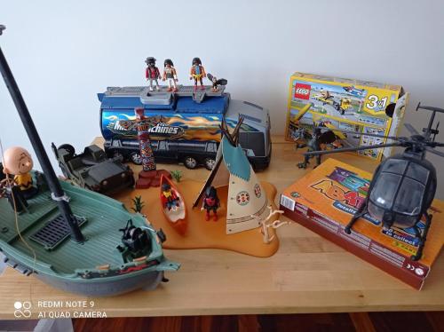 a table with toys and a toy helicopter and a guitar at Apto. Las LLamas S20 Santander, Garaje y Wifi in Santander