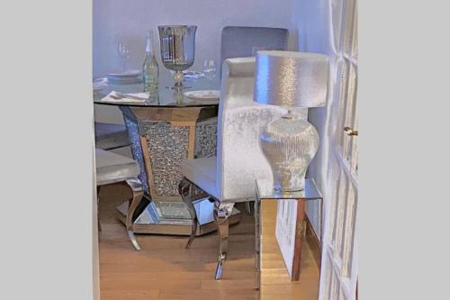 a desk with a chair and a table with a lamp at Beautiful Sea View 2 Bed Home in Port Glasgow