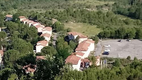 an aerial view of a house with a parking lot at Duplex village vacances Grospierres in Grospierres