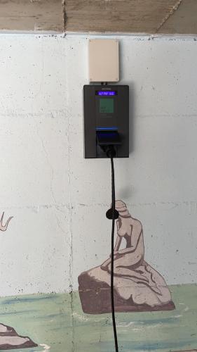 a pay phone on a wall with a drawing of a person at Casa Rosa in Luisago