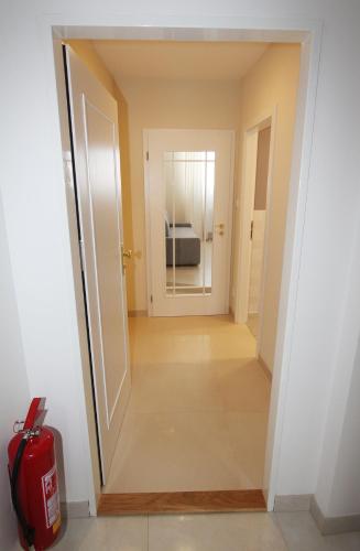 a hallway leading into a room with a fire extinguisher at Rezidence U prince č.3 in Jičín