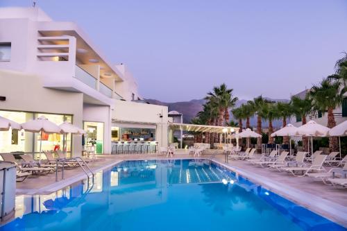 a pool at a hotel with chairs and umbrellas at Angela Suites Boutique Hotel in Sisi