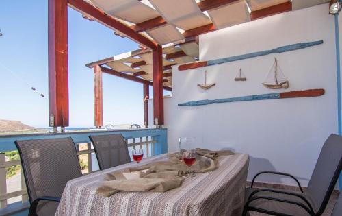 a dining room with a table and some boats on the wall at Fedra Apartments, View, Free Parking, 2mins to Beach in Palekastron