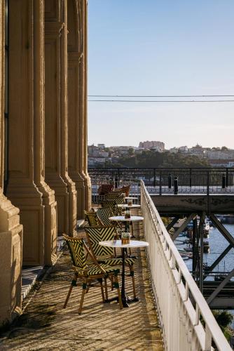 a row of tables and chairs on a bridge at Vincci Ponte de Ferro in Vila Nova de Gaia