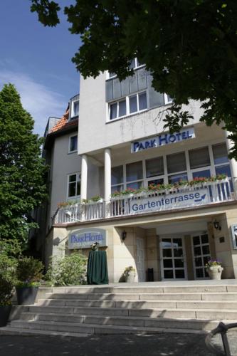 a building with a sign on the front of it at Parkhotel Altes Kaffeehaus in Wolfenbüttel