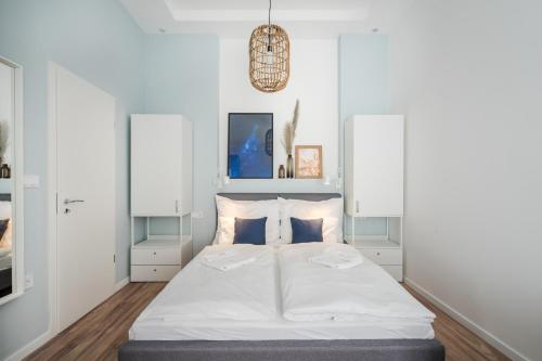 a bedroom with a large bed with white walls at A13- Boutique Apartments, Best Location, by BQA in Budapest