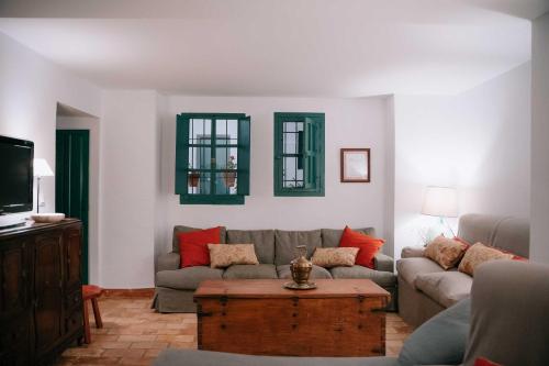 a living room with a couch and a coffee table at Bodega Boutique Finca Buytrón in Montilla