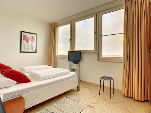 a bedroom with a bed and a window at Hello Zeeland - Appartement Port Scaldis 03-072 in Breskens